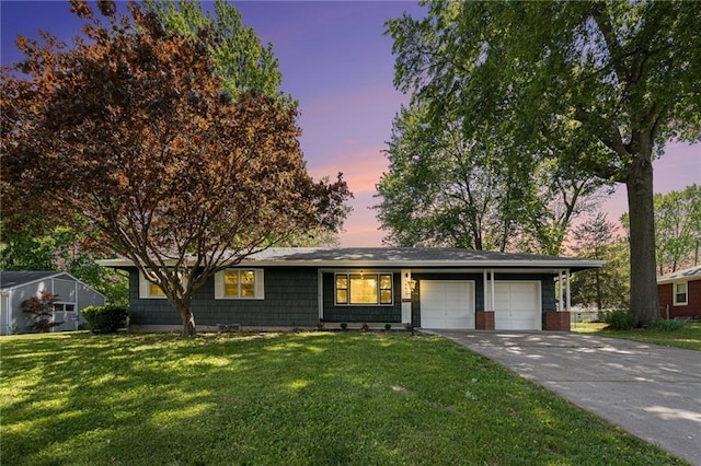ranch-style home with a garage, a front yard, and driveway