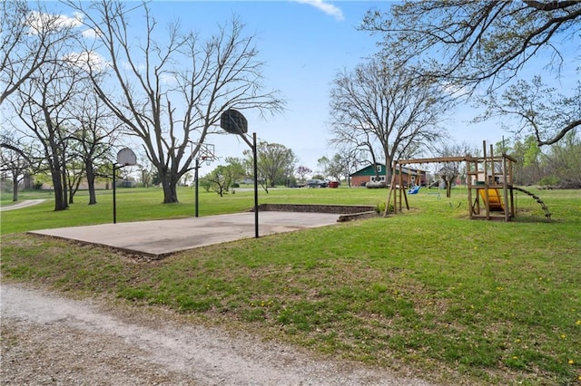 view of sport court featuring a lawn, community basketball court, and playground community