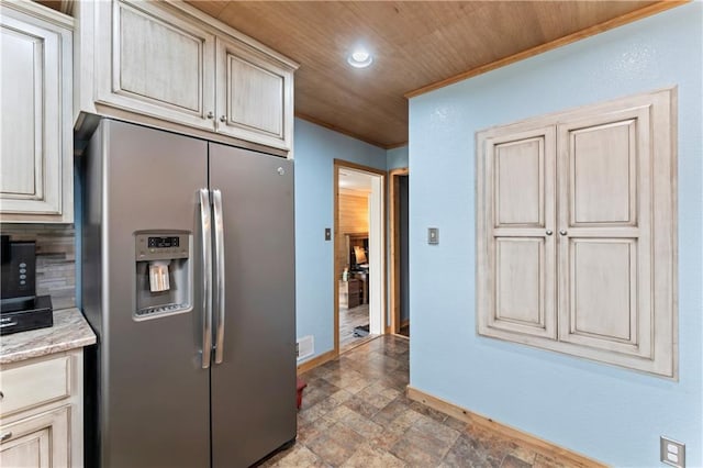 kitchen with baseboards, recessed lighting, wooden ceiling, stainless steel fridge with ice dispenser, and stone finish flooring