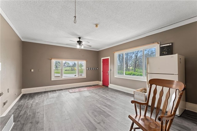 unfurnished room with ceiling fan, ornamental molding, a textured ceiling, and wood finished floors