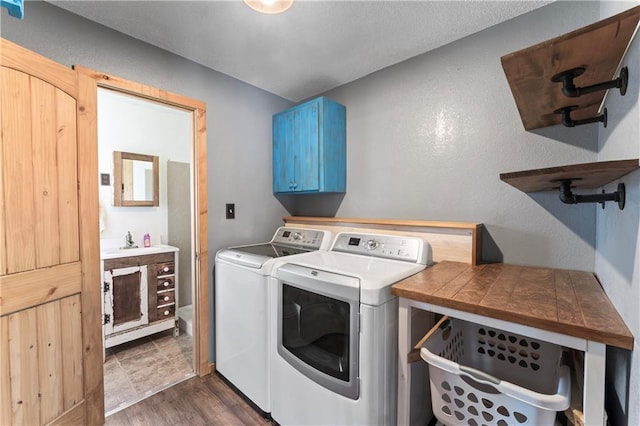 laundry area featuring dark wood-style flooring, cabinet space, and washer and dryer