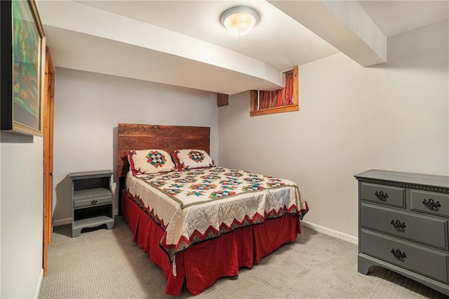 bedroom featuring baseboards and light carpet