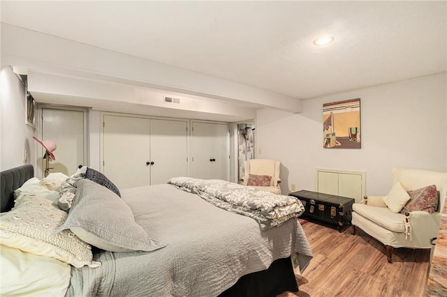 bedroom featuring visible vents and light wood-type flooring