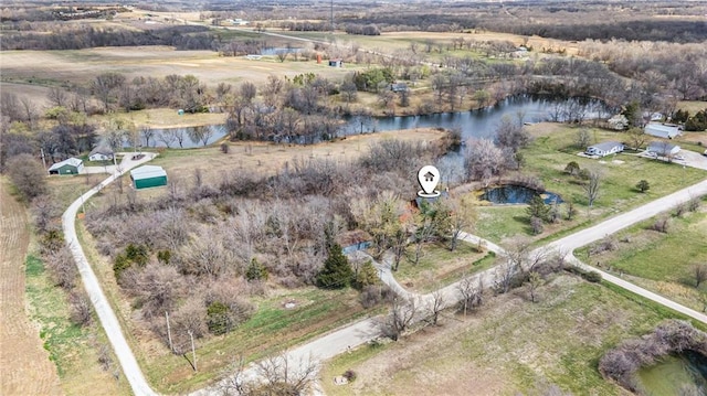 birds eye view of property featuring a water view and a rural view