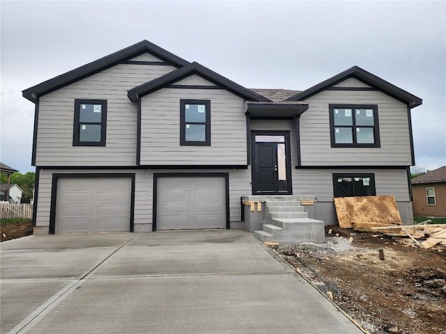 split foyer home with a garage, driveway, and entry steps