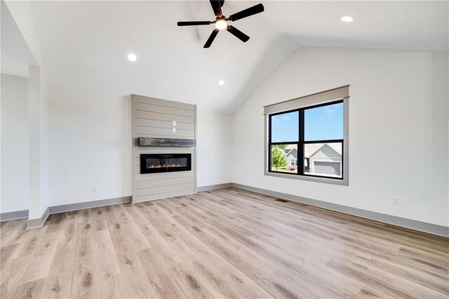 815 W Solomon Dr, Lone Jack, MO 64086 - unfurnished living room with a fireplace, vaulted ceiling, light wood-type flooring, ceiling fan, and baseboards