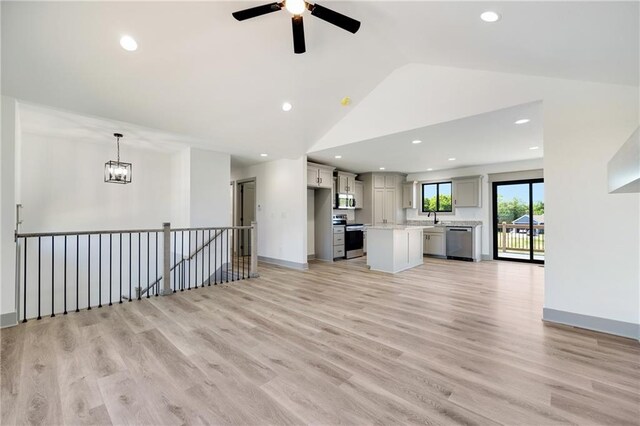 815 W Solomon Dr, Lone Jack, MO 64086 - unfurnished living room with lofted ceiling, light wood-style flooring, a ceiling fan, a sink, and recessed lighting