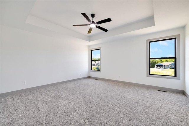 815 W Solomon Dr, Lone Jack, MO 64086 - empty room featuring a raised ceiling, baseboards, carpet floors, and ceiling fan