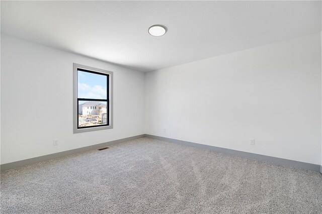 815 W Solomon Dr, Lone Jack, MO 64086 - spare room featuring carpet floors and baseboards