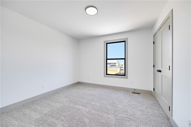 815 W Solomon Dr, Lone Jack, MO 64086 - unfurnished bedroom with carpet flooring, baseboards, and a closet