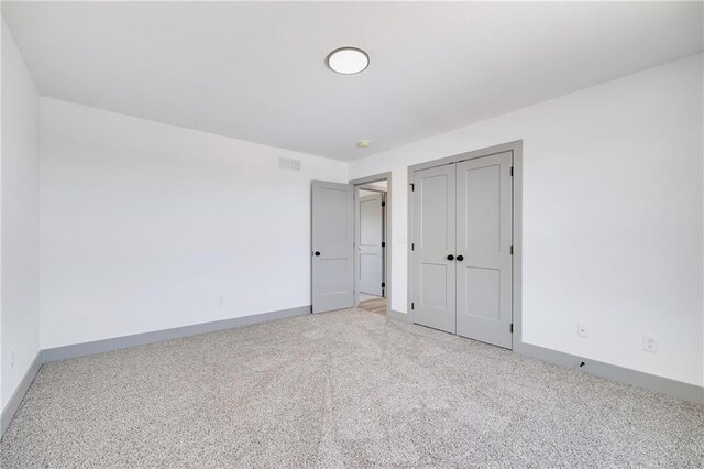 815 W Solomon Dr, Lone Jack, MO 64086 - unfurnished bedroom featuring carpet, baseboards, and a closet