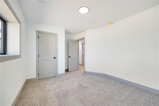 815 W Solomon Dr, Lone Jack, MO 64086 - unfurnished bedroom featuring light carpet and baseboards