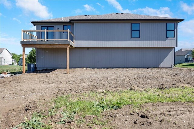 815 W Solomon Dr, Lone Jack, MO 64086 - back of property with a wooden deck and cooling unit