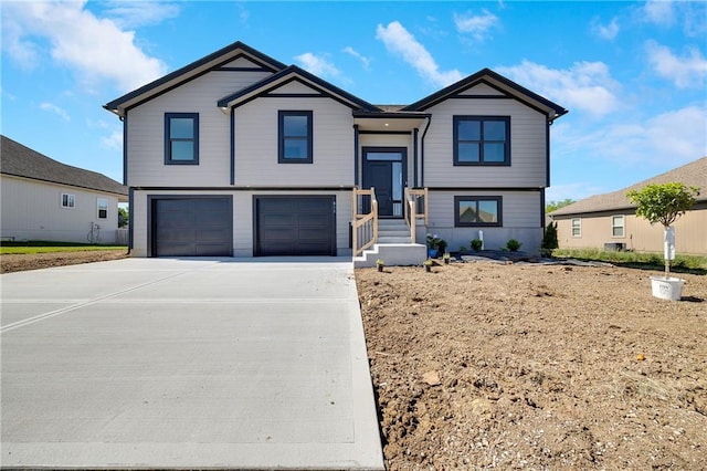 815 W Solomon Dr, Lone Jack, MO 64086 - split foyer home featuring an attached garage and concrete driveway