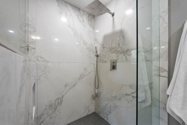 full bathroom featuring a marble finish shower