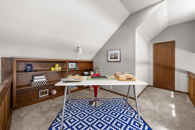 carpeted office featuring vaulted ceiling and a textured ceiling