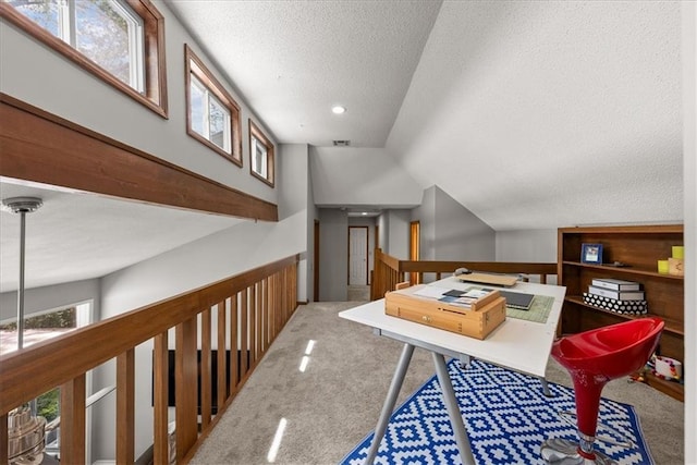office with a textured ceiling, vaulted ceiling, visible vents, recessed lighting, and carpet