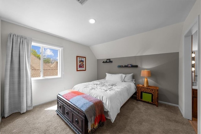 carpeted bedroom featuring vaulted ceiling and visible vents