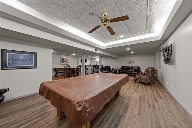 rec room with baseboards, wood finished floors, pool table, and a raised ceiling