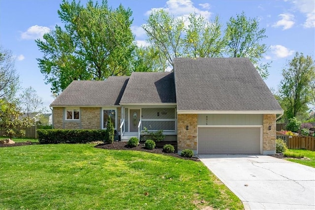 view of front of property featuring concrete driveway, a front lawn, fence, and stone siding