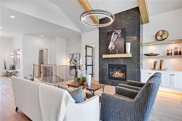 living area featuring a premium fireplace, light wood finished floors, and recessed lighting