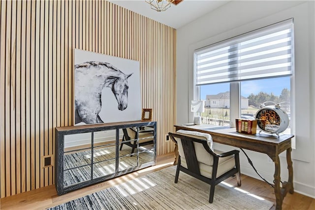 home office with wood finished floors, baseboards, and wallpapered walls