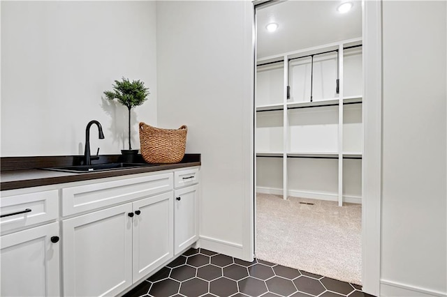 interior space with recessed lighting, vanity, and baseboards