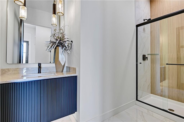 full bathroom with baseboards, marble finish floor, a stall shower, and vanity