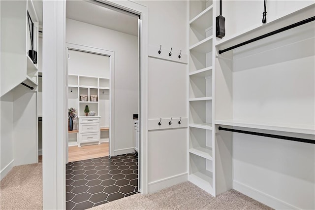 spacious closet featuring dark carpet