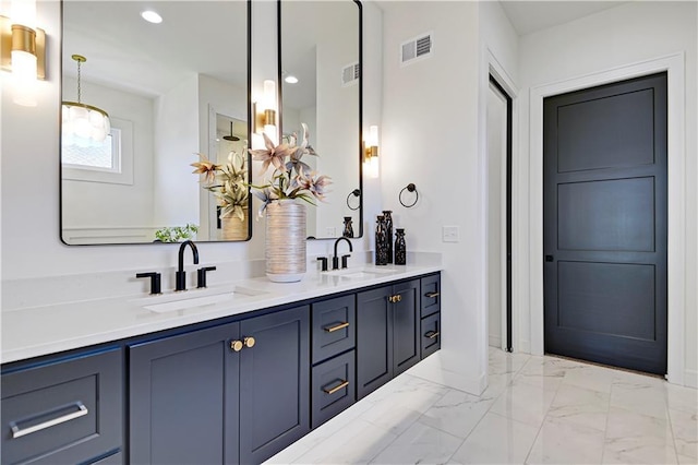 bathroom with double vanity, marble finish floor, a sink, and visible vents