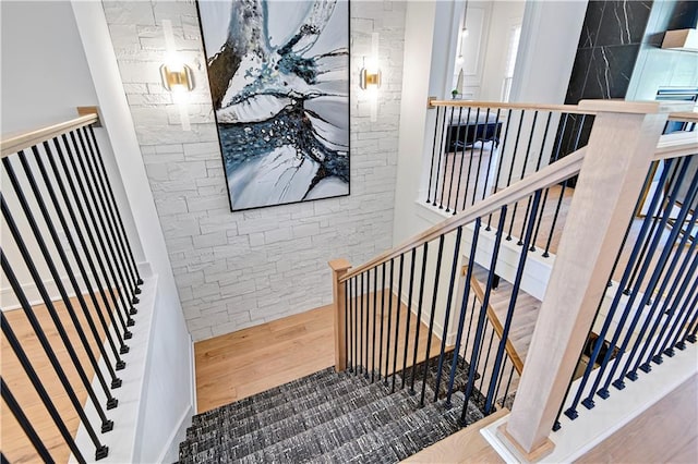 stairway featuring wood finished floors