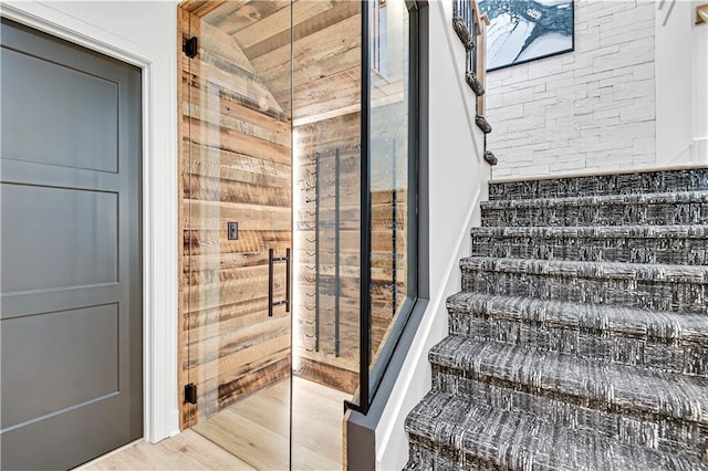 stairs with lofted ceiling and wood finished floors