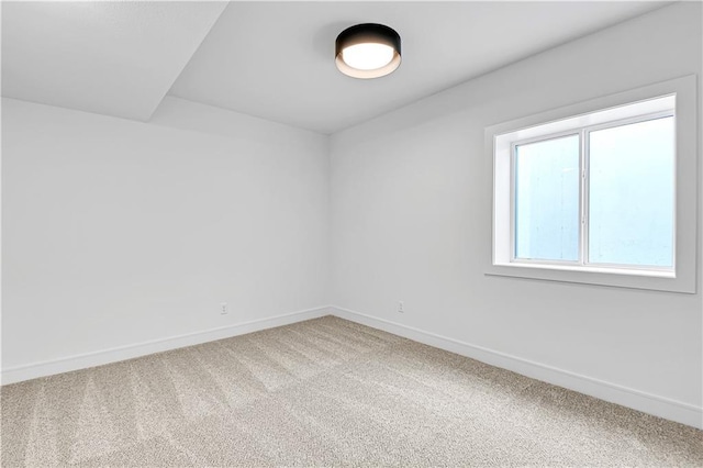 empty room with baseboards and carpet