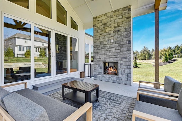 view of patio with an outdoor living space with a fireplace