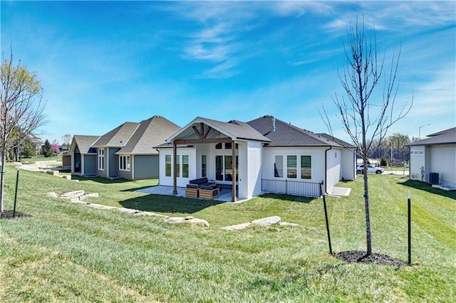 back of property with central air condition unit, a shingled roof, a yard, and a patio area