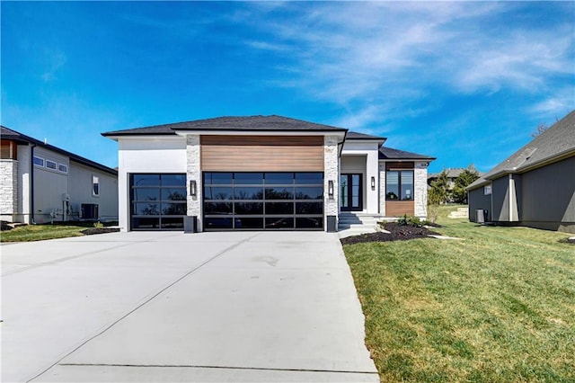 view of front of property featuring a garage, driveway, stone siding, and a front lawn
