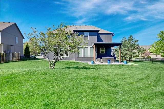 rear view of property with a lawn, a fenced backyard, and a patio area