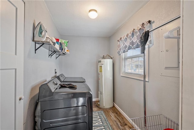 laundry room with baseboards, laundry area, water heater, light wood-type flooring, and separate washer and dryer