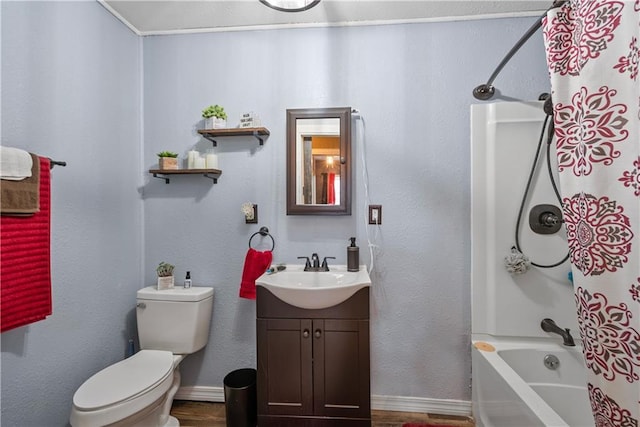 full bathroom with baseboards, toilet, wood finished floors, vanity, and shower / tub combo