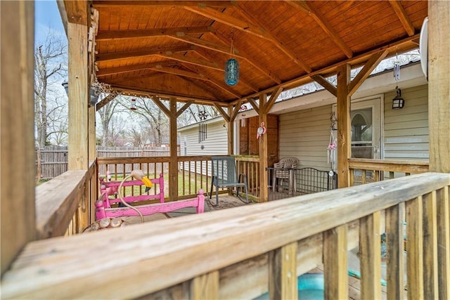 wooden terrace featuring fence