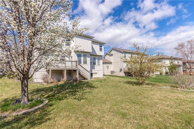 17281 S Kimble St, Olathe, KS 66062 - back of house featuring stairs, a deck, and a lawn