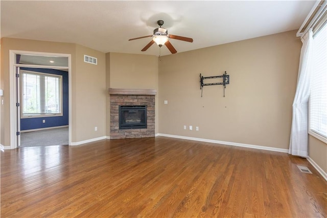 17281 S Kimble St, Olathe, KS 66062 - unfurnished living room featuring ceiling fan, healthy amount of natural light, and wood finished floors