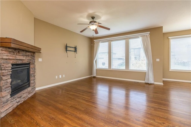 17281 S Kimble St, Olathe, KS 66062 - unfurnished living room with a ceiling fan, a stone fireplace, and wood finished floors