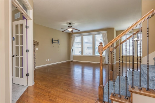 17281 S Kimble St, Olathe, KS 66062 - foyer entrance with stairway, a ceiling fan, healthy amount of natural light, and wood finished floors
