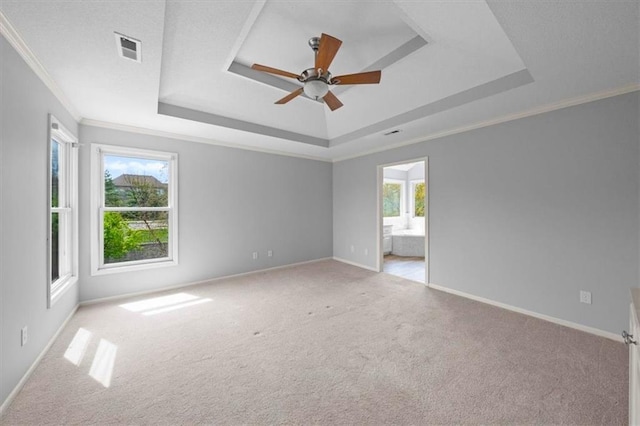 spare room featuring a ceiling fan, a tray ceiling, visible vents, and carpet