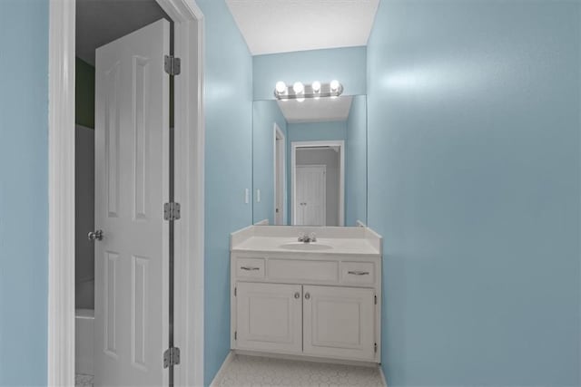 bathroom with baseboards and vanity