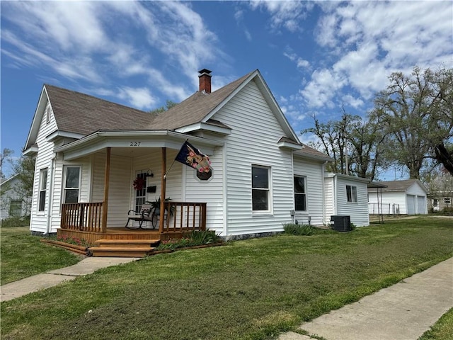 bungalow featuring covered porch, a front yard, and cooling unit