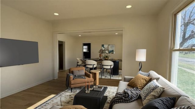 living area with baseboards, wood finished floors, and recessed lighting