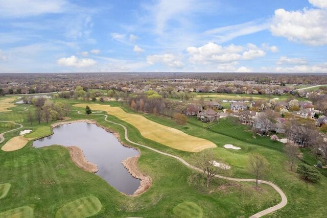 drone / aerial view featuring a residential view, a water view, and golf course view