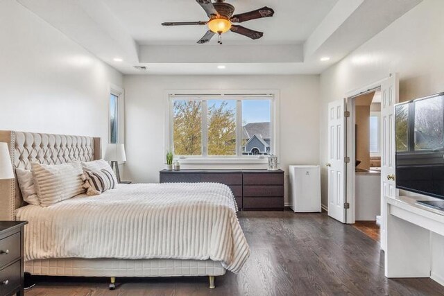 bedroom with recessed lighting, a raised ceiling, ceiling fan, and dark wood-style floors